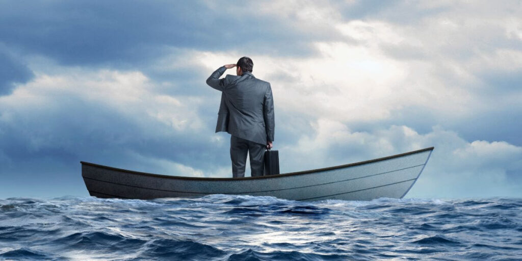 Businessman in boat scanning the horizon. 